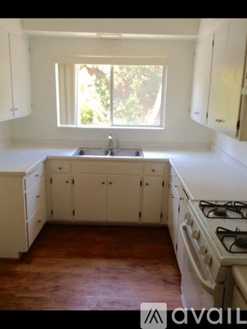 Thousand Oaks apartment for rent - A kitchen with white cabinets and a window.