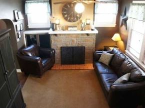 Pittsburgh house for rent - A living room with a fireplace and a clock on the wall.