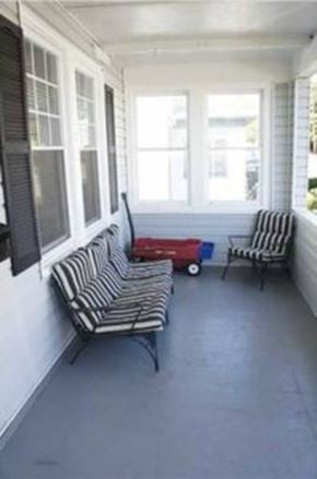 Pittsburgh house for rent - A striped couch and chair are on a porch.
