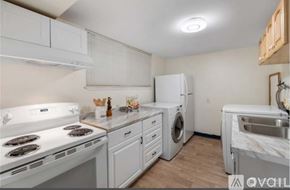 Auburn apartment for rent - A kitchen with white appliances and wooden cabinets.