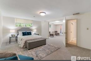 Auburn apartment for rent - A bedroom with a large bed and a window with blinds.
