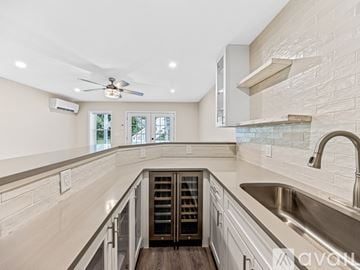 Asheville house for rent - A modern kitchen with a stainless steel sink and a ceiling fan.