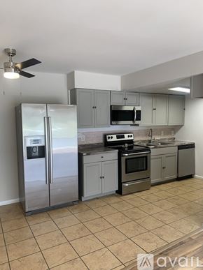 Cincinnati apartment for rent - A kitchen with a refrigerator, stove, and microwave.