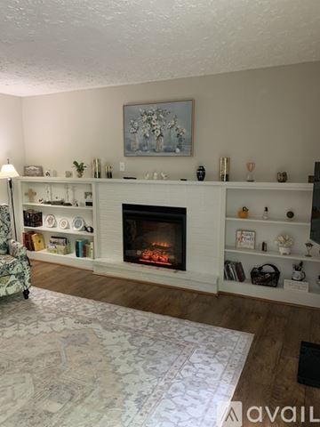 Cincinnati apartment for rent - A living room with a fireplace and a painting above it.