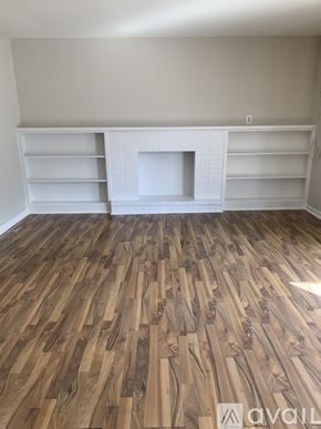 Cincinnati apartment for rent - A room with wooden flooring and a white fireplace.