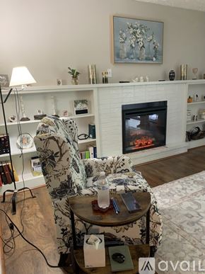 Cincinnati apartment for rent - A living room with a fireplace and a painting above it.