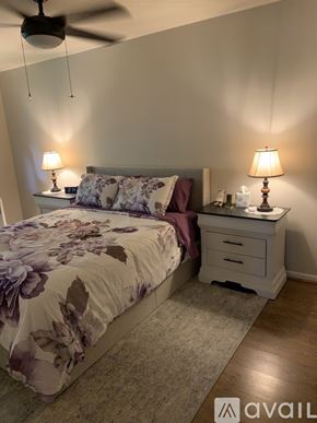 Cincinnati apartment for rent - A bedroom with a bed, nightstand, and two lamps.