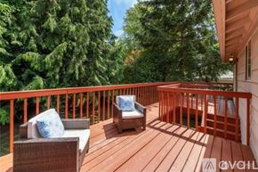 Auburn apartment for rent - A wooden deck with two chairs and a cushioned bench.