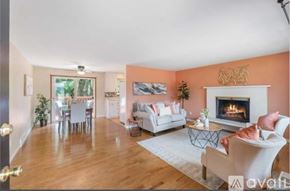 Auburn apartment for rent - A living room with a fireplace and a dining table.