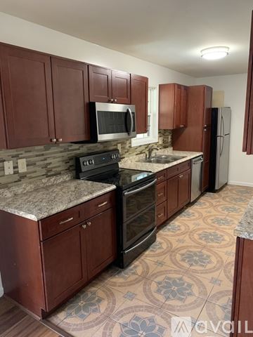 Cincinnati apartment for rent - A kitchen with brown cabinets and a patterned floor.