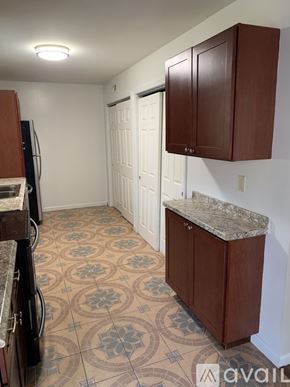 Cincinnati apartment for rent - A kitchen with brown cabinets and a patterned floor.