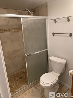 Cincinnati apartment for rent - A bathroom with a toilet and a walk-in shower.