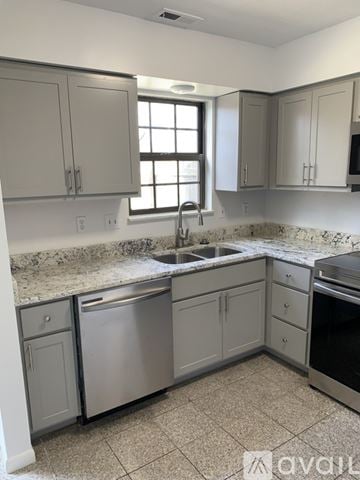 Cincinnati apartment for rent - A kitchen with granite countertops and stainless steel appliances.
