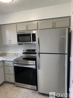 Cincinnati apartment for rent - A kitchen with a stainless steel refrigerator, oven, and microwave.