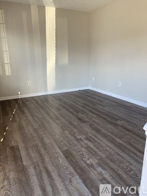 Cincinnati apartment for rent - A room with wooden flooring and white walls.