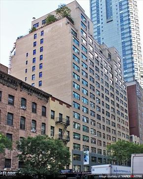 New York apartment for rent - a tall building in the middle of a city