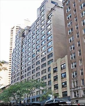 New York apartment for rent - a tall building with cars parked in front of it