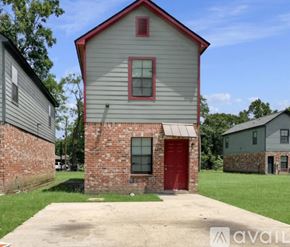 Baton Rouge house for rent - A house with a red door and a red window is for sale.