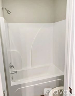 Baton Rouge house for rent - A white bathroom with a shower stall and a toilet.