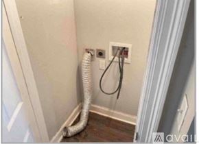 Baton Rouge house for rent - A white wall socket with a white extension cord plugged into it.