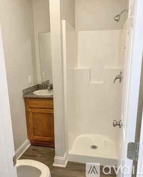 Baton Rouge house for rent - A white bathroom with a toilet, sink, and bathtub.