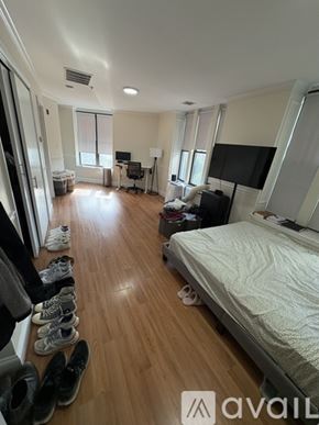 Boston apartment for rent - A bedroom with a bed, a desk, and a chair.