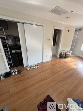 Boston apartment for rent - A room with wooden floors and a white door.