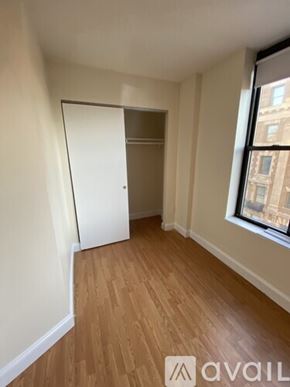 Boston apartment for rent - A room with wooden flooring and a white door.
