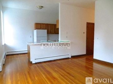 Boston apartment for rent - A kitchen with white appliances and wooden cabinets is available for rent.