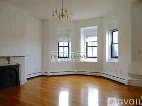 Boston apartment for rent - A living room with a fireplace and a chandelier.