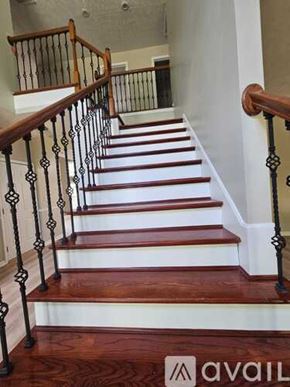 Louisville house for rent - A staircase with a wooden handrail and white risers.