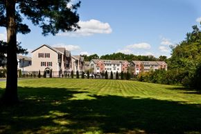 Glassboro apartment for rent - a row of houses in front of a green field