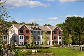 Glassboro apartment for rent - a view of a building with a pond in front of it