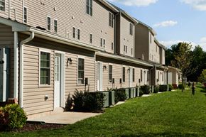Glassboro apartment for rent - a row of houses with white siding and green grass