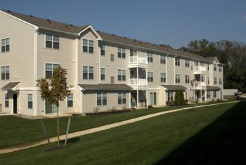 West Deptford apartment for rent - a large apartment building on the side of a green lawn