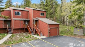 Breckenridge house for rent - A red building with a garage door is surrounded by trees.
