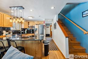 Breckenridge house for rent - A kitchen with wooden cabinets and a blue wall.
