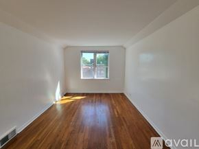 Chicago apartment for rent - A room with wooden floors and a window.