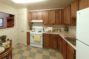 Lambertville apartment for rent - a kitchen with wooden cabinets and a white stove