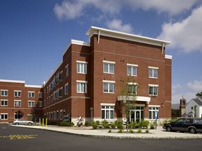 Lawrence apartment for rent - a rendering of a brick building on a street corner