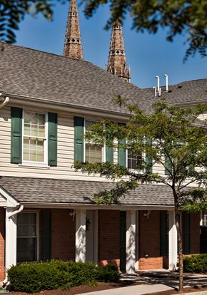 Elizabeth apartment for rent - a white house with green shutters and a tree in front