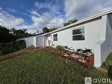 Cutler Bay apartment for rent - A spacious kitchen with white cabinets and a central island.