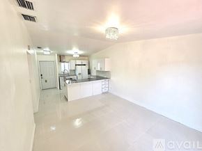 Cutler Bay apartment for rent - A modern kitchen with white cabinets and a large island.