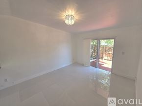 Cutler Bay apartment for rent - A kitchen with white cabinets and a white floor.