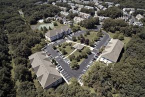 Ocean Township apartment for rent - an aerial view of an apartment complex with parking lot and trees
