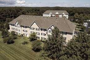 Ocean Township apartment for rent - an aerial view of a large building surrounded by trees