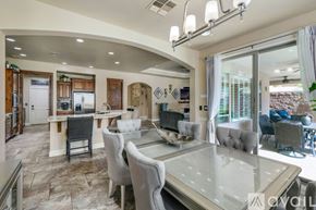 Lake Havasu City house for rent - A modern dining room with a glass table and grey chairs.