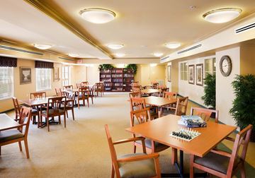 Rahway apartment for rent - a dining room with tables and chairs and a library
