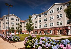 Rahway apartment for rent - an apartment building with flowers in front of it