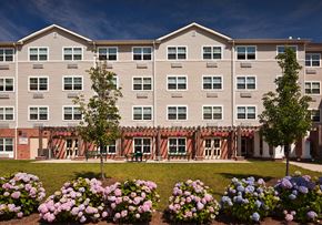 Rahway apartment for rent - an apartment building with flowers in front of it